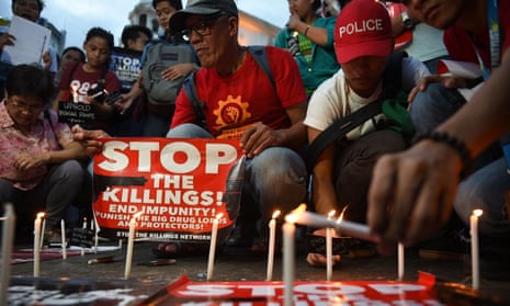 Activists light candles outside a Manila church. The vigil was for victims of extra judicial killings carried out as the Philippines government pursues its war on drugs.