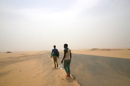 Ethiopian migrants walk beside a road in Yemen en route to Saudi Arabia, where they hope to find work