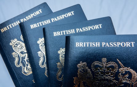 The sun reflects on the cover of four UK-issued passports