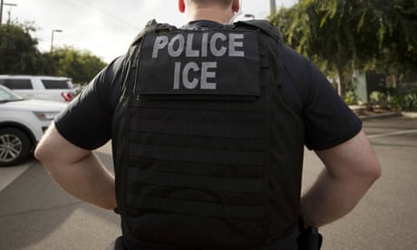 back of officer's vest says 'POLICE ICE'