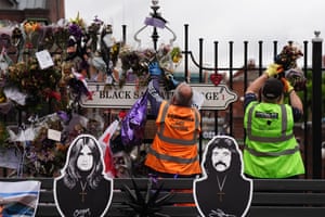 Council workers and volunteers take down tributes left for Ozzy Osbourne at the Black Sabbath Bridge bench on Broad Street, Birmingham