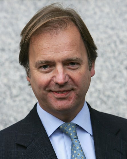 A picture of Hugo Swire wearing a suit and looking at the camera