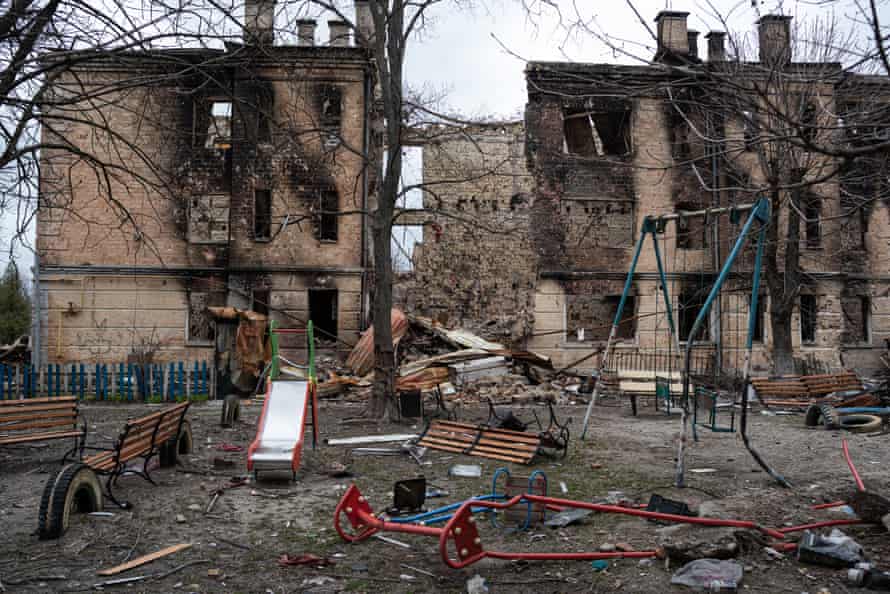 A damaged playground is seen next to a heavily damaged apartment building in Hostomel, Ukraine.