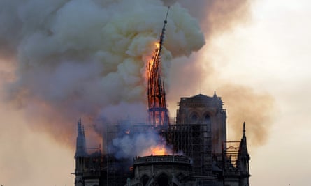 The steeple and spire of the landmark Notre Dame cathedral collapses in flames in central Paris on April 15, 2019.