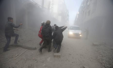 Residents and a member of the Syrian Red Crescent carry an injured man, after an air-strike in eastern Ghouta.