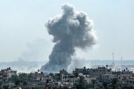 A smoke plume billows following Israeli bombardment north of Nuseirat in the central Gaza Strip on 23 April.
