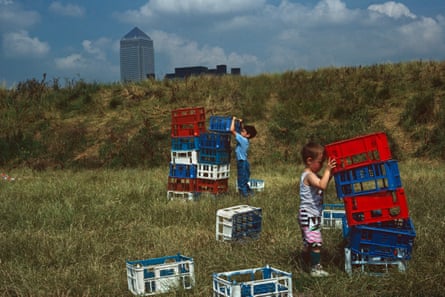 In 1991, children build their own towers out of crates as a newly-constrcuted Canary Wharf looms in the background.