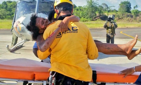 A rescue worker helping Murillo after her rescue.