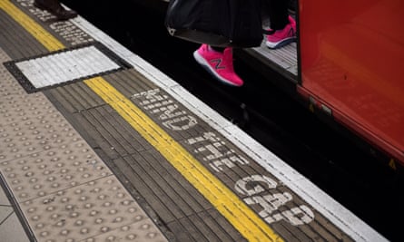 A woman boards an underground train at Bank station as the deadline nears for companies to report their gender pay gap on April 4, 2018 in London, England.