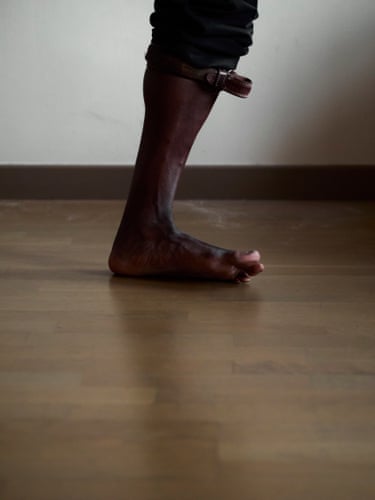Self-portrait in black suit pants and brown leather belt, Black Belt, 2025Caught between one step and the next, the body appears tolose its balance as a leather belt tightens around the leg.Displaced from its expected position, the belt turns movement into friction, revealing how patriarchal masculinity can be carried through the restraints, corrections and instabilities imposed on the body.