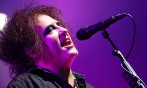 Robert Smith of the Cure singing into microphone