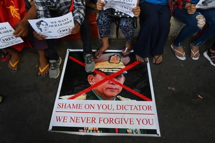 In this file photo taken on February 11, 2021, protesters step on a banner showing an image of Myanmar military chief Senior General Min Aung Hlaing during a demonstration against the military coup in Yangon.
