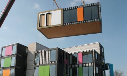 A modular home being lifted by a crane in London