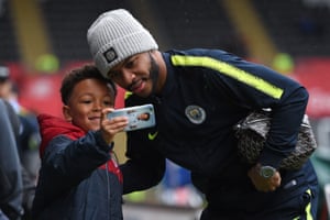 Manchester City’s Raheem Sterling has a selfie taken with a young fan as he arrives for their FA Cup quarter-final match against Swansea City at the Liberty Stadium.