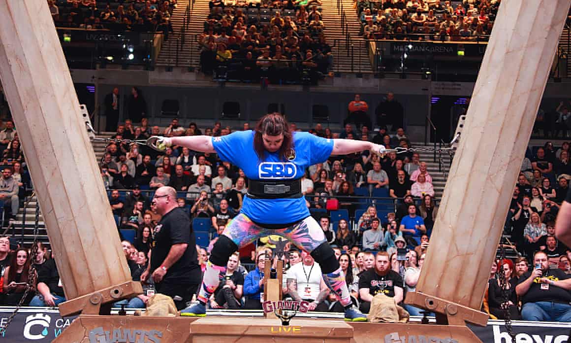 Rebecca Roberts pulling on two columns in an arena