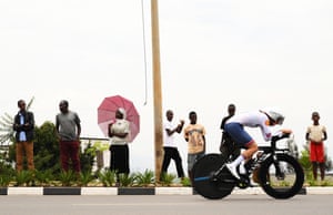 A cyclist rides past spectators