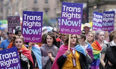 People carrying banners in support of trans rights in Glasgow.