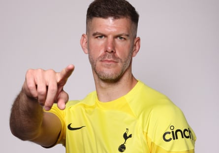 Fraser Forster poses in a Tottenham shirt after completing his move to the club.