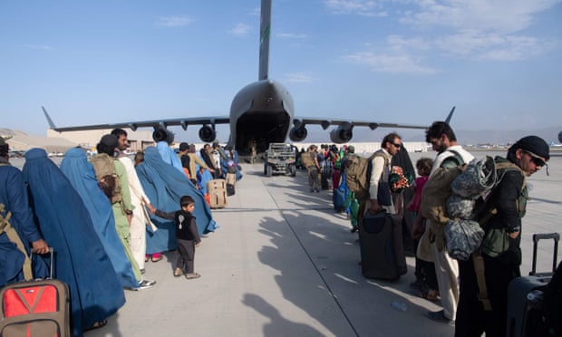 Evacuees wait to board a US air force plane at Kabul airport, 25 August.
