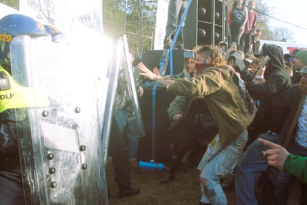Police with riot shields face ravers