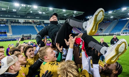The players give a lift to head coach Johannes Moesgaard after promotion was clinched last season.