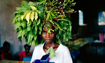 A market woman brings cassava leaves into the central market area of Tubmanberg in 2003.