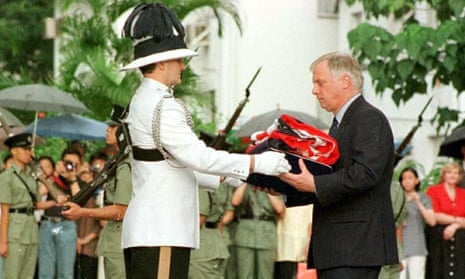 Chris Patten receives the union flag after it was lowered for the last time at Government House in Hong Kong on 30 June 1997.