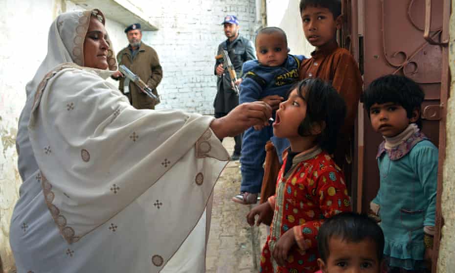 A Pakistani health worker administers polio drops to a child during a vaccination campaign in Quetta