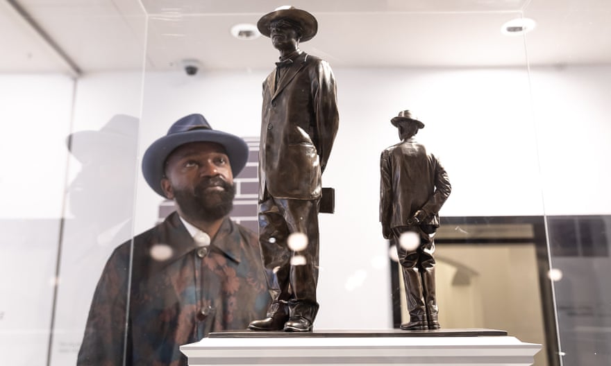 Samson Kambalu inspects a model of an antelope, depicting John Chilembwe and John Chorley