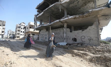People amid destroyed buildings