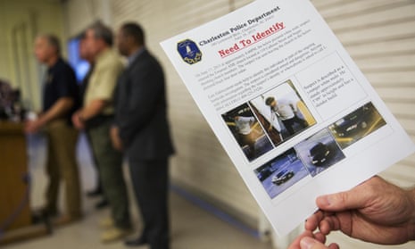 Charleston Emergency Management Director Mark Wilbert holds a flier, Thursday, June 18, 2015, distributed to media with surveillance footage of a suspect wanted in connection with a shooting Wednesday at Emanuel AME Church, in Charleston, S.C. (AP Photo/David Goldman)