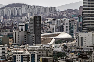 Zaha Hadid. Completed 2014Rising from the historical heart of Seoul like a colossal spacecraft that crash-landed, the Dongdaemun Design Plaza is a monument to audacity – fluid, futuristic and post-structural. Yet beneath the curvature lies a deeply Brutalist soul. Although cloaked in an aluminium skin, the structure is undergirded by a concrete skeleton – its flowing interior voids, cantilevered volumes and massive spans recall the muscular confidence of old-school Brutalism