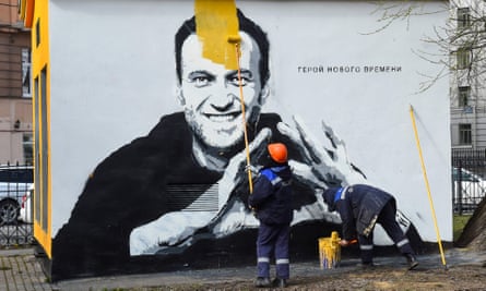 A worker paints over graffiti of jailed Kremlin critic Alexei Navalny in Saint Petersburg.