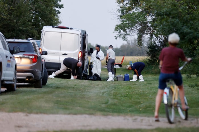 A police forensics team investigates a crime scene after multiple people were killed and injured in a stabbing spree in Weldon, Saskatchewan.