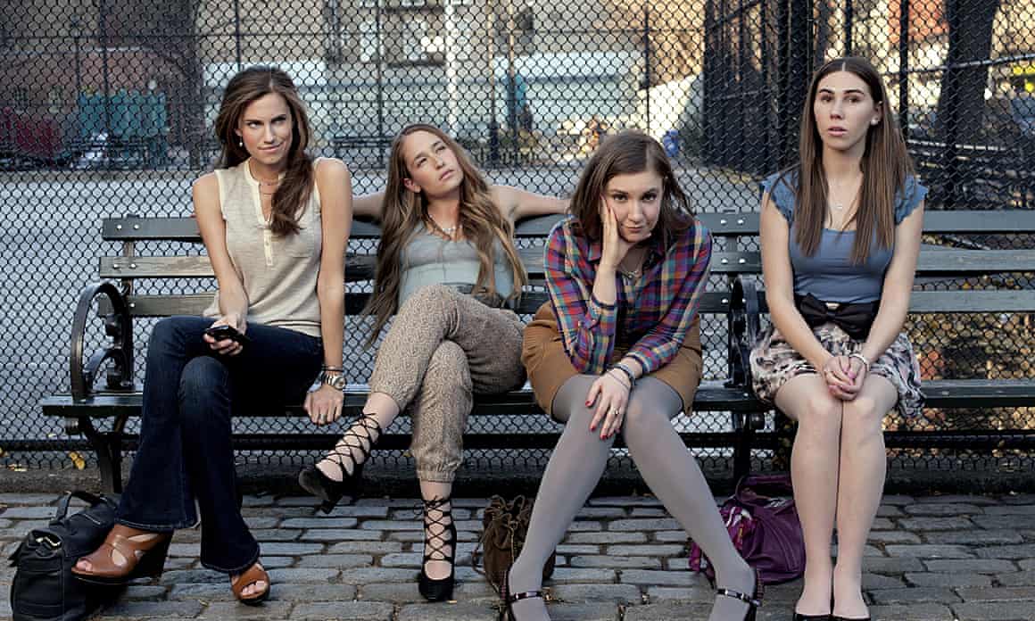 Allison Williams and three other characters from Girls sit on a bench