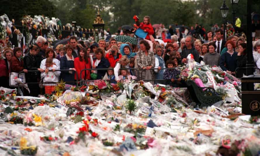 Thousands of mourners gather to lay flowers and cards at the gates of Kensington Palace in London.