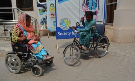 Wajid Ali, right, is one of the 6,000 people to have received free wheelchairs from Qureshi’s organisation.