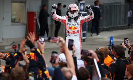 Max Verstappen celebrates in front of his Red Bull team.
