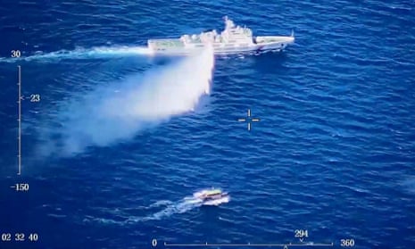 Screengrab taken from a video released on 8 August showing a Chinese coastguard ship using a water cannon near a Philippine vessel.