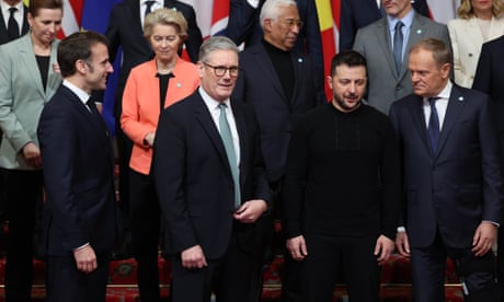European leaders gathered in front of a row of flags