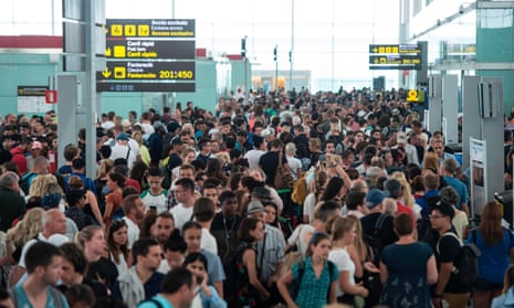 Passengers wait to pass through security control at Barcelona’s El Prat airport.