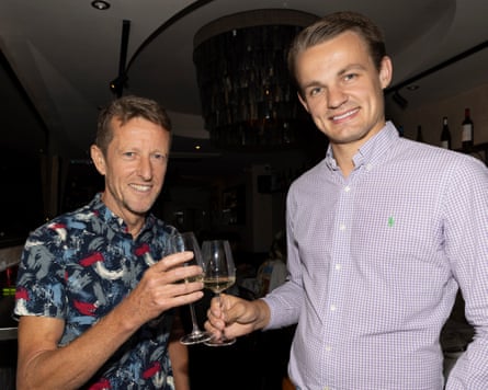 Tim and Lewis standing inside with drinks