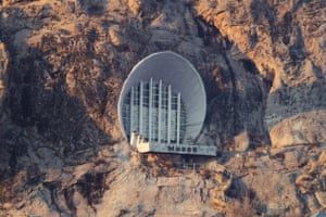 p93 Museum on the Mountain Suleiman-Too, Osh, Kyrgyzstan, Built in 1978 Architect: K. Nazarov: The building is an historical-ethnographic museum. Its facade spans the mouth of a cave containing petroglyphs (ancient rock inscriptions) allowing them to be preserved in their original form. The cave is an object of cultural importance and is included on the UNESCO World Heritage List. The most spectacular architectural element of the museum is its concrete arch with panoramic glazing, divided by vertical ridges. This construction essentially closes the natural entrance to the cave. The lower floor of the two-storey museum complex inside has been enlarged, while the upper floor remains in its natural state. Today over 400 exhibits from the Kyrgyz Museum of Spiritual Culture are displayed here.