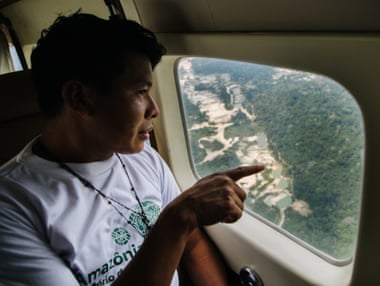 Indigenous activist Daniel Saw Munduruku looks down at an illegal gold mine during a monitoring flight over the Amazon last month