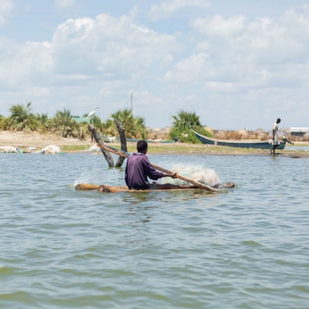 A fisher rows his log boat on Lake Turkana