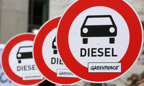 Protest banners outside a German federal parliament hearing on the Volkswagen emissions scandal, which has had a knock-on effect on UK car sales.