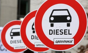 Unofficial traffic signs protesting about the danger of diesel cars are held aloft during a march to the Bundestag in Berlin in March.