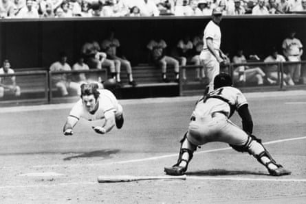 The Reds’ Pete Rose dives into home plate past the glove of Giants catcher Dave Rader in July 1972.