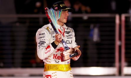 Max Verstappen celebrates with his trophy wearing an Elvis-inspired race suit after winning the Las Vegas Grand Prix in 2023