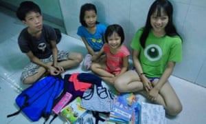 The children of Tran Thi Thanh Loan, pictured with their new school purchases made from funds provided by a crowd fund in Australia.